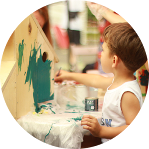 Little Boy Painting Birdhouse